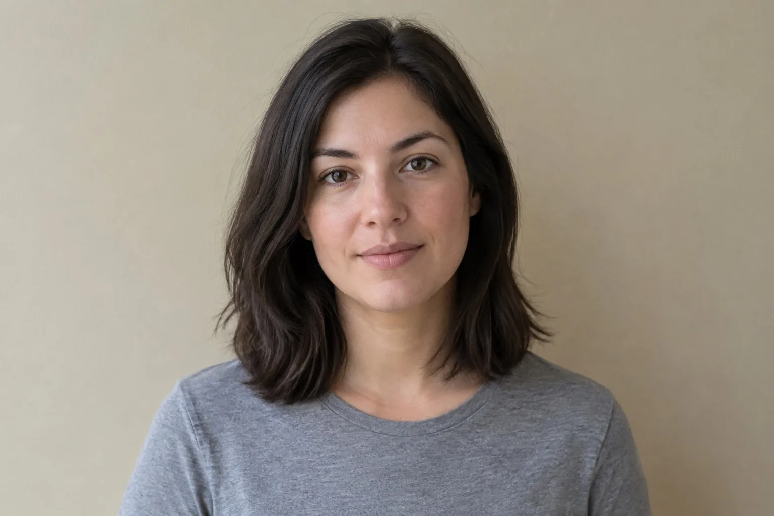 Portrait against a plain beige wall before an AI background edit